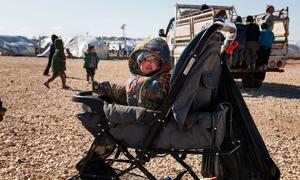 A young child sits in a stroller in the annex of Al-Hol camp in northeast Syria.